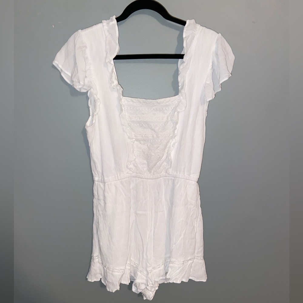 A white shirt sleeve romper size large